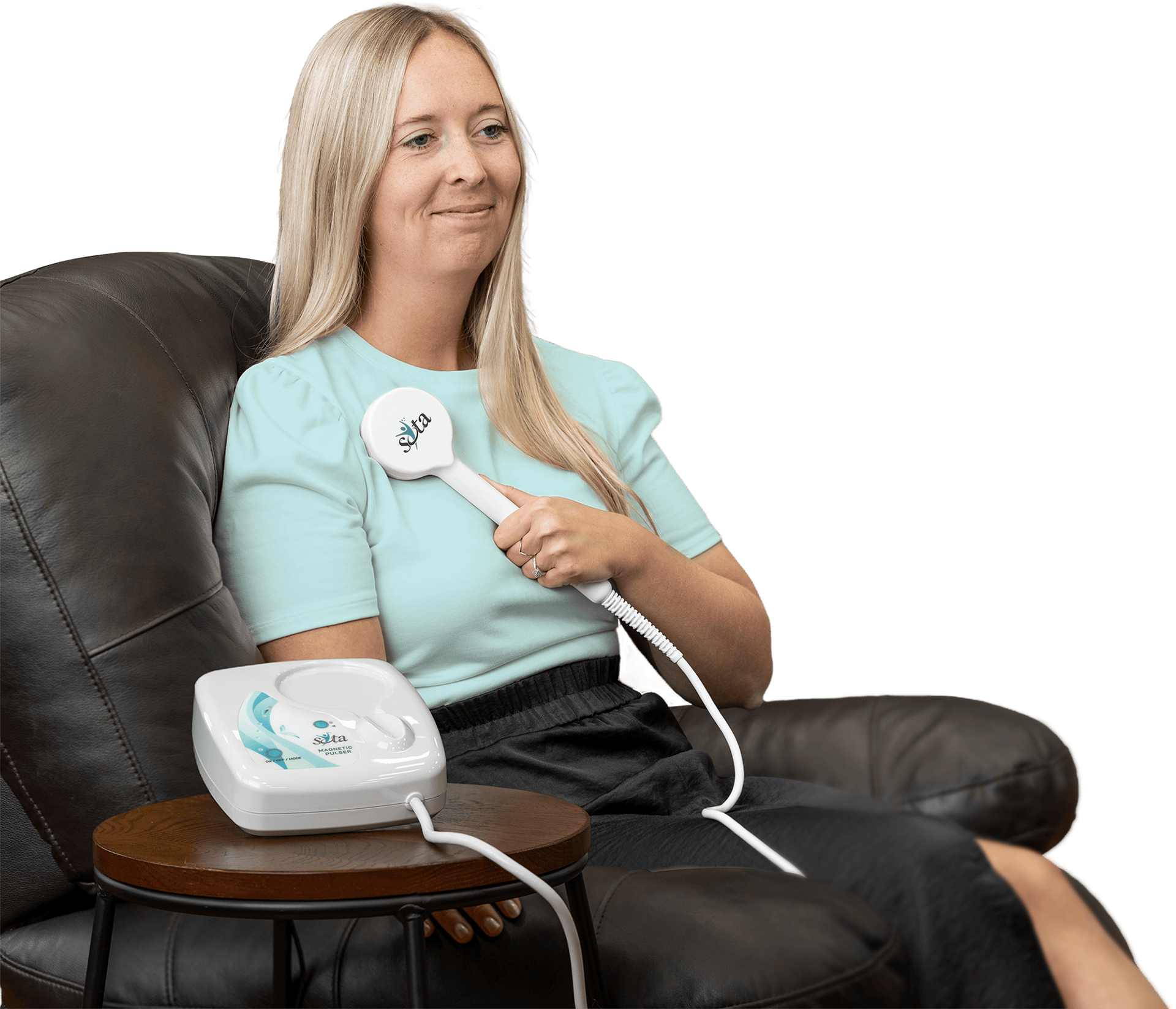Woman relaxing in a chair using the Magnetic Pulser Hand Paddle on her shoulder