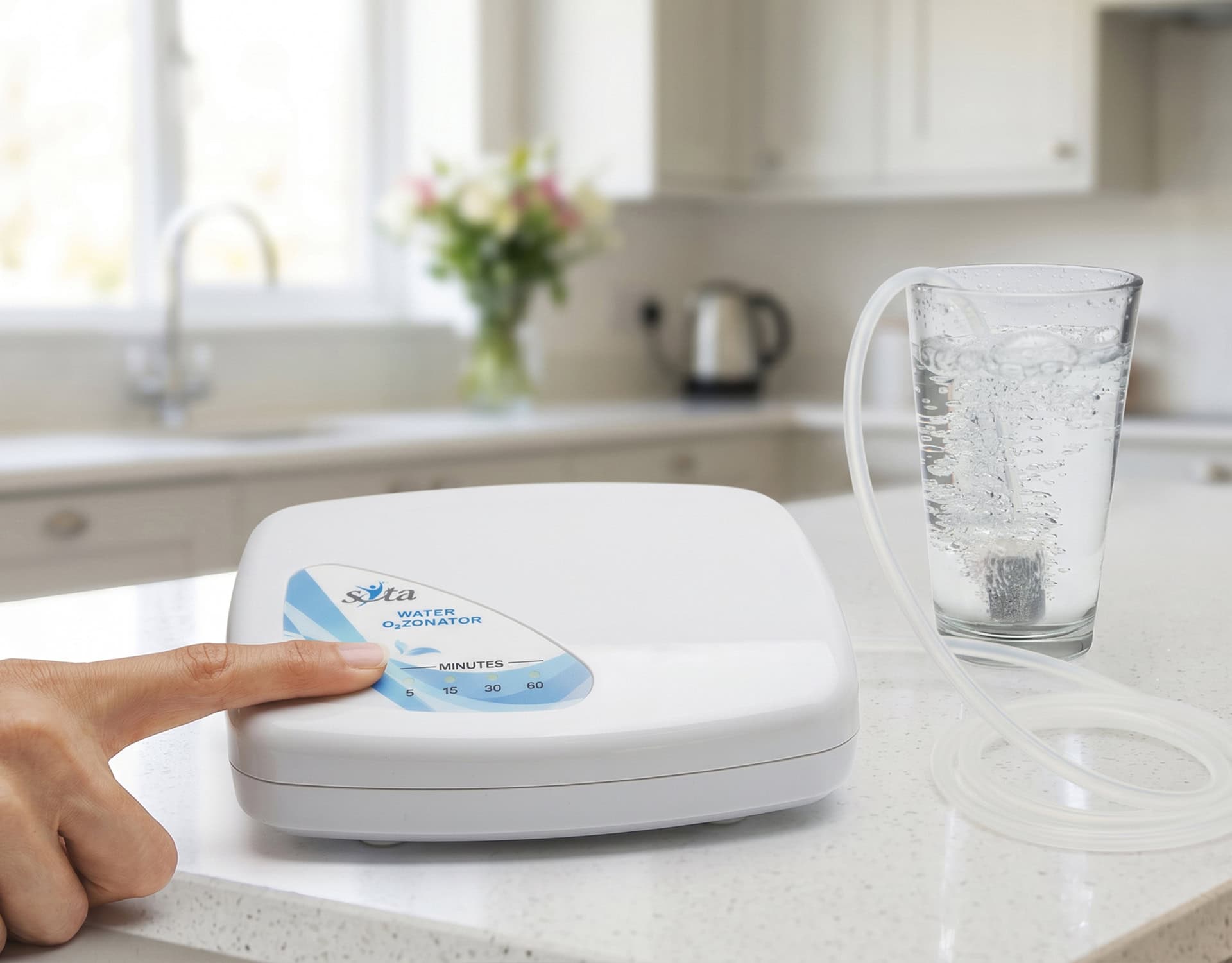 Pressing the on button on the Water Ozonator while bubbles rise in the glass
