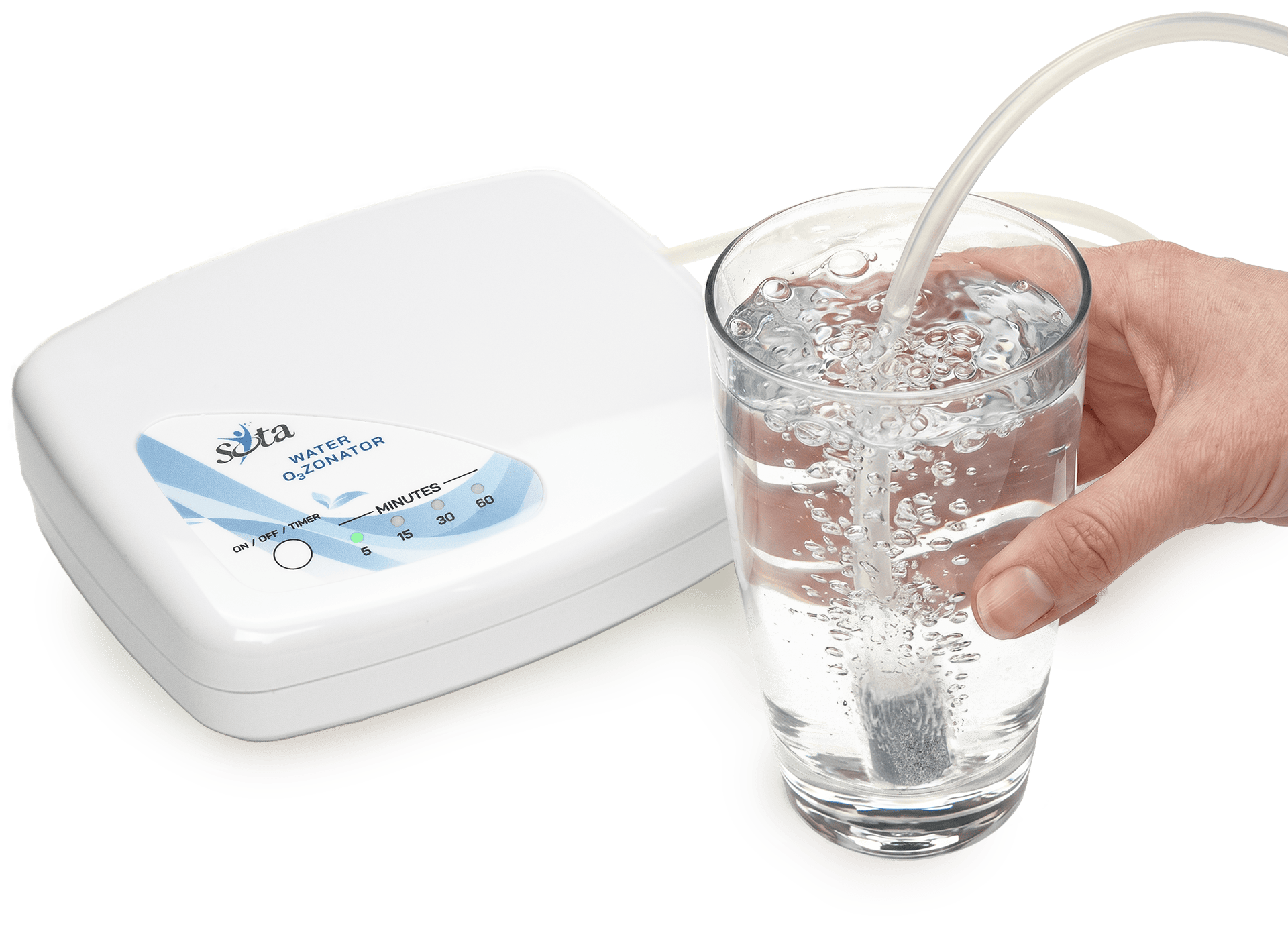 The SOTA Water Ozonator unit next to a hand holding a glass of ozonated water with visible bubbles